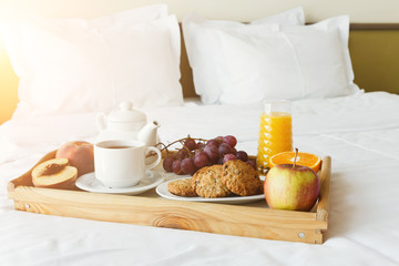 Breakfast served in bed on wooden tray
