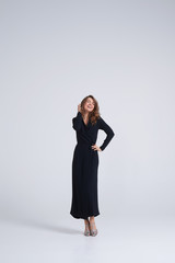 Candid trendy young model posing at camera in studio