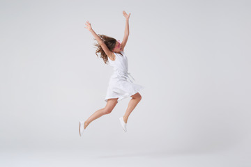 Fototapeta na wymiar Cheerful beautiful young woman jumping