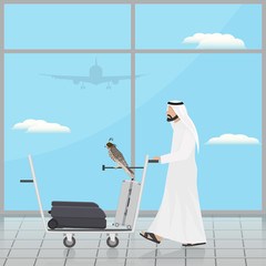 Arab with a falcon on a trolley at the airport