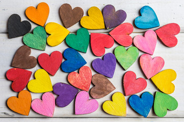 Fototapeta na wymiar Colorful wooden hearts on white boards background