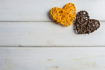 Colorful wooden hearts on white boards background