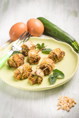 filled rolled up zucchinis with pine nuts, selective focus