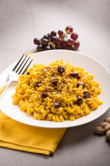 risotto with saffron grape and pistachio nut, selective focus