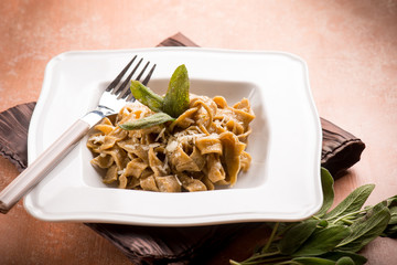 tagliatelle with butter sage and parmesan cheese, selective focus