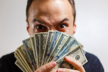 Portrait of businessman with dollars in his hands man with eyes like