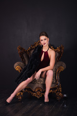 sexy woman fur coat sitting vintage chair