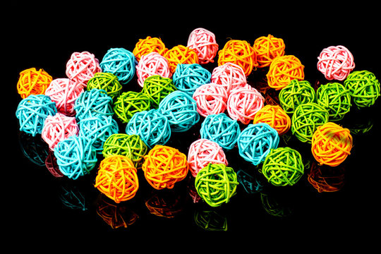 Multicolor rattan light balls on black background. Creative deco