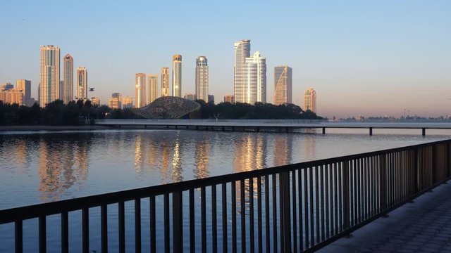 View to skyscrepers and lake from embarkment. Sharjah, Khalid Lake.