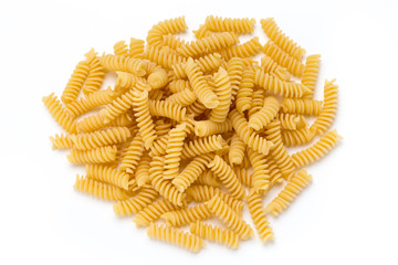 Uncooked fusilli pasta isolated white background.