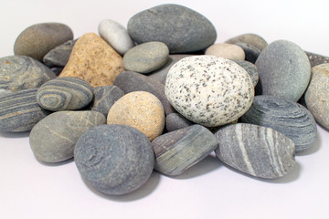 Fototapeta na wymiar A large pile of smooth textured sea rocks.