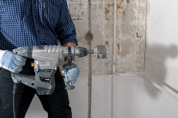 Man holding electrical hammer drill