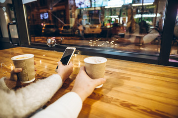couple sit in cafe in front of big glass window