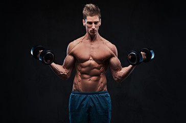 Fototapeta na wymiar Athletic shirtless male biceps dumbbell workout.