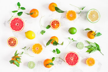 Fruit background. Colorful fresh fruits on white table. Orange, tangerine, lime, lemon, grapefruit. Flat lay, top view