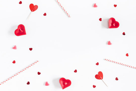 Valentine's Day. Frame made of candles, confetti on white background. Valentines day background. Flat lay, top view, copy space