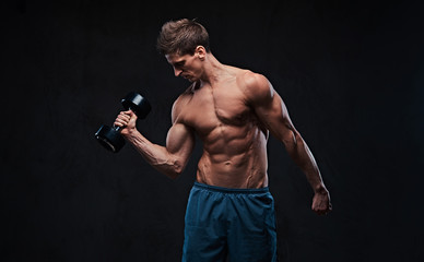 Fototapeta na wymiar Athletic shirtless male biceps dumbbell workout.