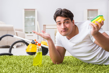 Young husband man cleaning floor at home