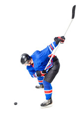 Ice Hockey player performing slap shot isolated on white background