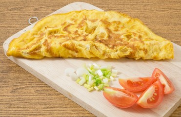 Thai  Omelette with Tomatoes and Scallion on Wooden Board