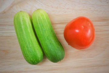 Fresh Tomato with Cucumbers on Cutting Board