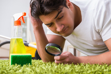 Young husband man cleaning floor at home