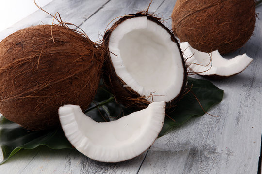 coconut and coconut cut in half on wooden background