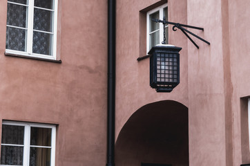 Street lamp hanging on the facade of old building