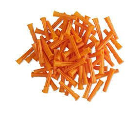 a pile of orange plastic dowels on isolated background