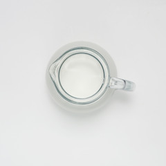 glass jug with milk on white background