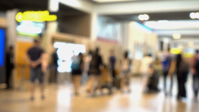 blurred footage with travellers walking in airport terminal