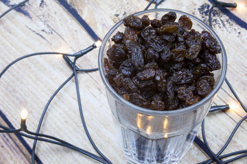Collection of various raisins on wooden background with lights