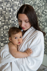 mother in a Bathrobe and with a child