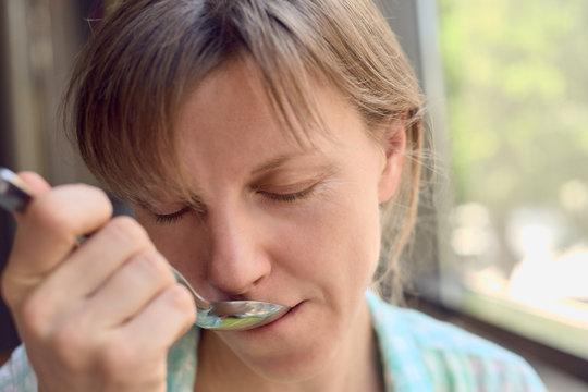 Woman With Spoon In Mouth