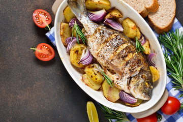 Baked dorado with Provencal herbs and potatoes.