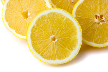 Fresh cut lemons on a white background. Lemons cut in half on a white background close-up.