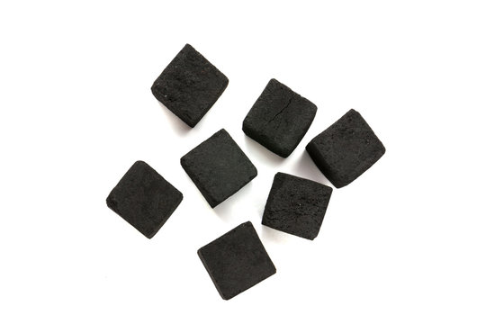 Cubes of coconut coal for a hookah on a white background. Coal for shisha from coconut shell close-up.