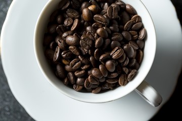 Cup with whole coffee beans