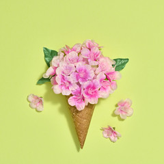 Ice Cream Cone with Bouquet of Flowers. Trendy fashion Style. Spring Summer Floral concept. Creative Minimal. Pink Blossom, Bright Color. Art