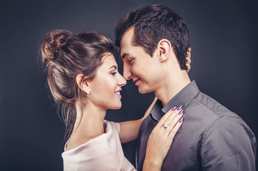 Couple in love hugs on black background. Valentines day