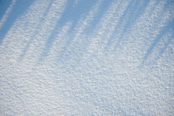 snow with shadows for texture or background at sunny day, bright light, flat lay, top view, clean and nobody