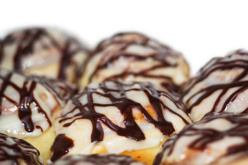 Sweet buns smeared with cream and chocolate-covered close-ups