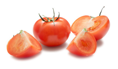 Tomato with leaflets and sliced tomato slices on a white background