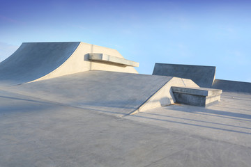 skate park generic concrete ramps outside with blue sky - obrazy, fototapety, plakaty