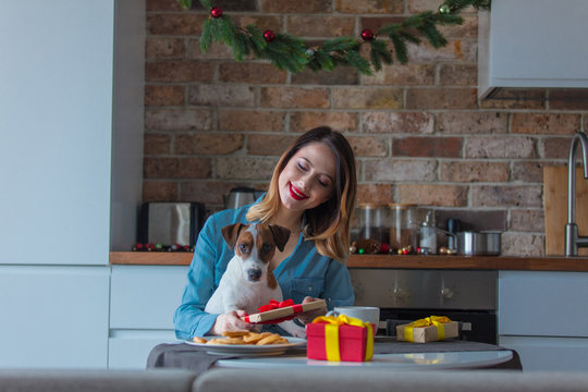 Portrait Of Redhead Woman With Dog At Kitchen