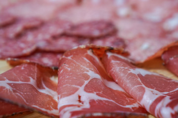 Food tray with delicious salami and ham. Meal platter with selection