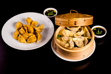 Yaki Gyoza. Japanese pan-fried dumplings in bamboo steamer