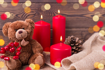 Obraz na płótnie Canvas Valentine background. Teddy bear keeps the heart, candles and a bump in rustic style . Selective focus. Copy space