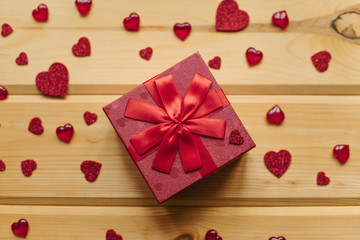 A gift in a beautiful crane box tied with a ribbon on a wooden surface.