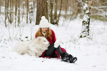 Pretty Young Woman in Snowy Winter Forest Park Walking with her Dog White Samoyed Seasonal 